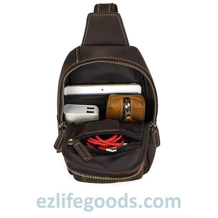 EZLIFEGOODS-Dark Brown leather sling bag with compartments containing electronic items on a white background, branded 'ezlifegoods.com'.